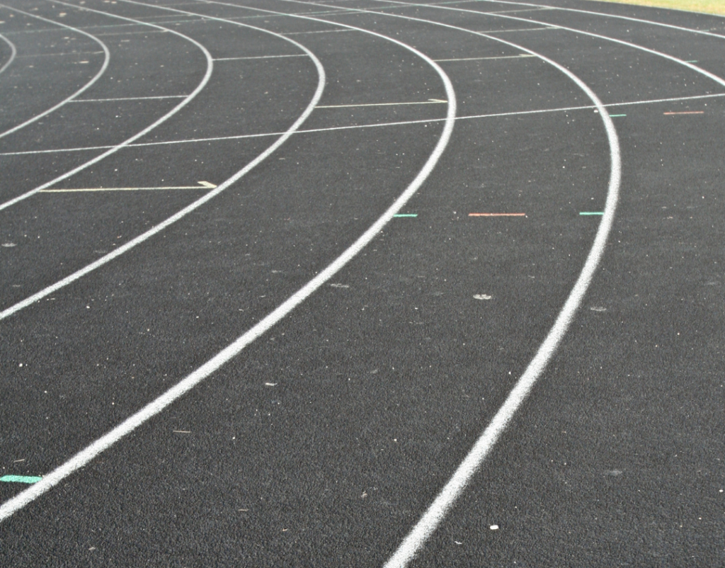 a black track curve with white lane lines